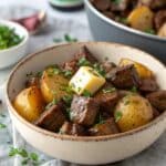 Steak bites and potatoes in slow cooker with garlic butter